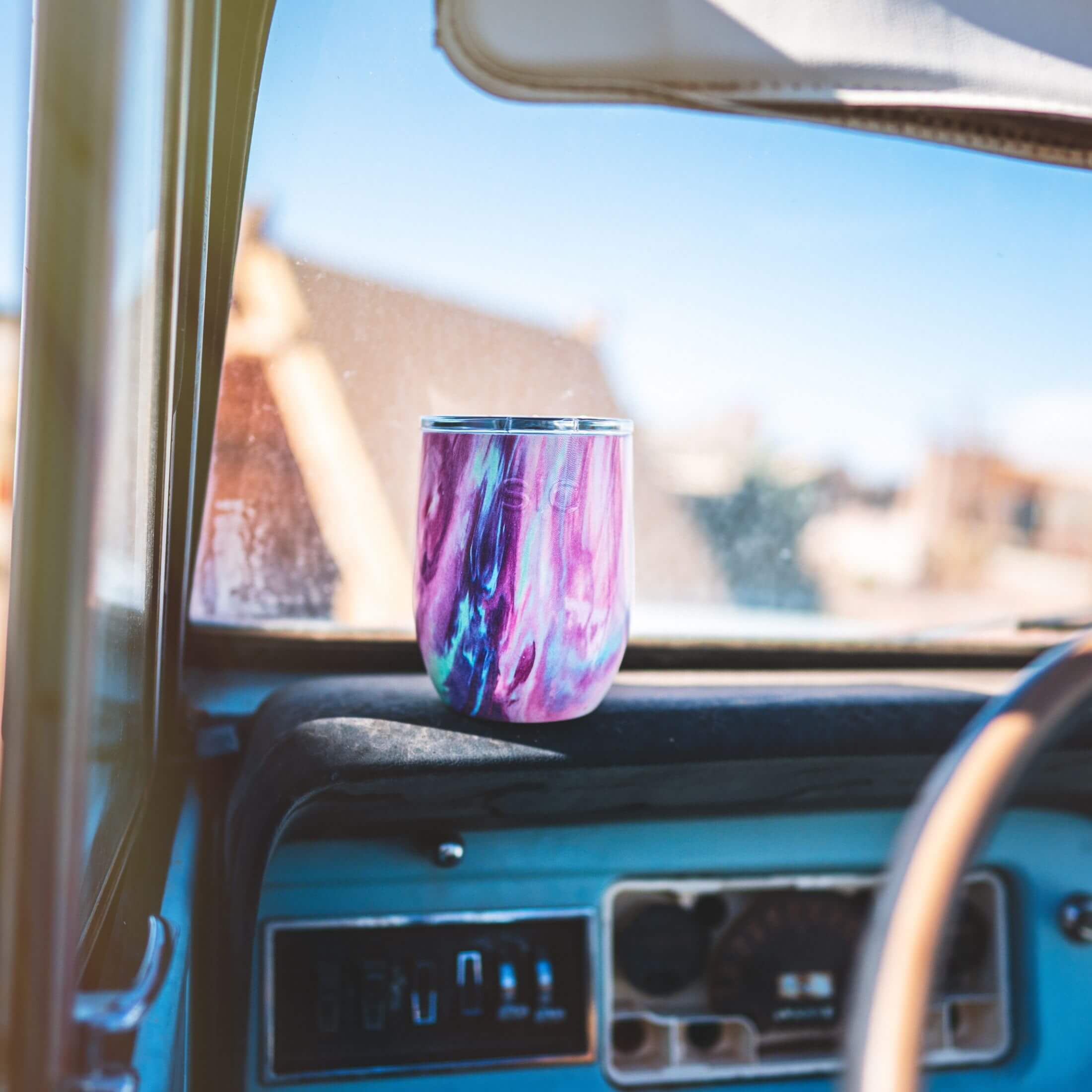 Cotton Candy Stemless Wine Glass on a car dashboard