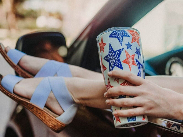 Woman in Sandals holding a 30 oz. Tumbler with stars design