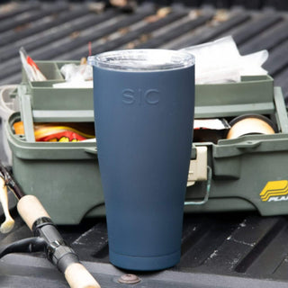 Matte Blue Tumbler on a Truck Tailgate next to tacklebox